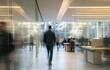 © PNG - Blurred figures walk through modern office with glass walls and trees