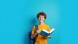 © Putra - Happy Young Student Holding Book and Smiling at Camera.