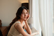 © Parichat - Young Asian woman smiling looking at camera relaxing indoors