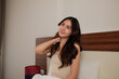 © Parichat - Young woman relaxing in bed feeling refreshed