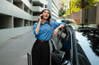 © Parichat - Asian businesswoman talking on smart phone near car