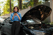 © Parichat - Woman using phone calling for roadside assistance