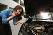 © Parichat - Young woman calling for help, seeing car trouble