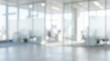 © Celt Studio - bright abstract defocused interior of modern contemporary corporate office building featuring glass partition walls empty desks and natural sunlight creating clean business background