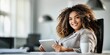 © NovaVision - Smiling plus-size businesswoman with curly hair using a tablet in a modern office setting