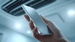 © rifai_art - Hand holding silver smartphone in futuristic interior office