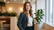 © Vasiliy - Smiling professional woman in a checkered blazer. Confident female executive in a modern office setting. Corporate career and leadership concept