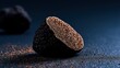 © FoxGrafy - Exquisite black truffle halved on a dark, textured surface, revealing its captivating intricate marbling.