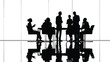 © MdSafi - Silhouettes of a business team in a conference meeting setting