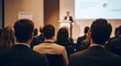 © Yassine - Professional business speaker presenting important information to a large audience of interested corporate office employees