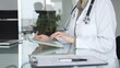 © rogerphoto - Doctor woman accessing patient data on digital tablet, managing healthcare records in modern medical office. Medicine, health care and science concept