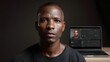 © Thares2020 - A professional man with a serious expression stands before a laptop displaying a biometric facial recognition interface
