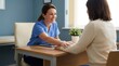 © Hudson - Friendly Medical Professional Consults Patient During a Comfortable and Caring Office Visit