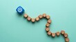© alex - Strategic journey towards success A blue target die guides a winding path of wooden blocks, symbolizing leadership and clear goals