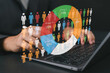 © Nirusmee - Businessperson analyzing statistical data on laptop, representing demographic analysis, market segmentation, target audience insights, and data-driven marketing strategy.