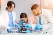© Pixel-Shot - Scientists with microscope studying samples in laboratory