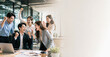 © Sukifli Dakheng - Excited business team celebrating success in office