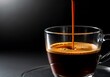© MstRahima - A glass cup of espresso on a saucer with coffee being poured into it