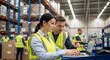 © Bali Adventure Co - Business colleagues reviewing inventory data in large warehouse
