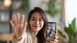 © sup - Woman on video call waving hello