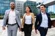 © Westend61 - Smiling business team walking together in the financial district