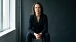 © Svitlana - Woman generating confidence sitting on a dark background, studio confidence portrait with calm pose, dark minimalist background and empowered personal presence, high detail, cinematic depth, balanced
