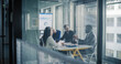 © Gorodenkoff - Business Leaders Sit in a Glass Meeting Room Reviewing Digital Dashboards, Discussing Performance Metrics, Setting Priorities, and Planning Strategy to Improve Sales, Marketing, Finance, Customers