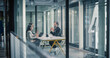 © Gorodenkoff - Two Business Professionals Sit Across a Table in a Glass Office, Discussing Project Goals, Reviewing Performance Dashboards, Clarifying Requirements, Managing Risk, Agreeing on Governance Structure