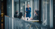 © Gorodenkoff - Female Business Leader Stands at the Front of a Glass Conference Room, Using a Digital Tablet to Present Strategy, Guide a Planning Session, Review Performance Metrics, and Coordinate Decisions