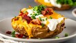 © Rindi - Loaded baked potato with cheese and bacon.