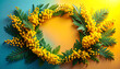 © Dewi - Circular floral wreath made of yellow mimosa flowers and green pine needles, framed against a gradient blue and yellow background, symbolizing spring and nature