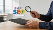 © Na - Businessman holding tablet and magnifying glass examining SEO graphic floating above digital marketing strategy analysis search engine optimization concept for website growth
