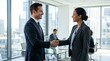 © salam - Two Business Professionals Shaking Hands in Modern Office Setting.