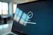 © Vera - A laptop screen with a progress bar for a software update in a modern office setting.