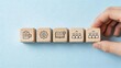 © Yi - Business management strategy team growth concept wooden cubes with icons representing planning improvement learning development and people expansion on blue background