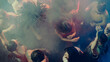 © master1305 - Aerial view of people dancing energetically in a smoky, vibrant club atmosphere. Concept of nightlife party, youth, summer, festivity, celebration