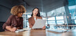 © Stock 4 You - Two professional women businesswomen in modern office reviewing document, one taking notes at table, business meeting, teamwork, coaching and analysing paperwork collaboration. Banner, copy space