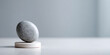 © perfectlab - Minimalist balanced stone on white platform