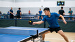 © Kaluya Stock - Ping pong player in action, male athlete focused on hitting table tennis ball with paddle during match in indoor arena