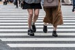 © Moritz Wolf/imageBROKER - Two pedestrians crossing zebra crossing, close-up, Shibuya Crossing, Shibuya, Udagawacho, Tokyo, Japan