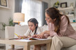 © Art_Photo - Mother looking at cute asian little daughter drawing with color pencils, Happy family childhood development, creative art education, parenthood childcare, early learning cognitive growth, mother day