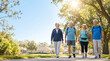 © dinda - Active group of happy senior friends walking outdoors together in a sunny neighborhood park celebrating Older Americans Month and healthy aging.