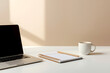 © GFX RONI - Modern laptop with a notebook and a coffee cup on a clean desk