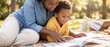 © Aurora Aesthetics - african american mother son reading book park picnic blanket family outdoor bonding learning close up of black mom and little boy enjoying story together lying on rug in sunny green summer garden