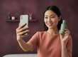 © Breezze - Young East Asian woman filming a selfie video while holding a product bottle for beauty vlogging, social media marketing and wellness content creator advertising