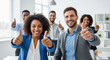 © KAMRAN - Happy diverse corporate team showing thumbs up perfect for positive company culture and successful business communication