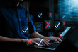 © Supatman - Document review verification and error check concept. Professional using laptop with files, approved check marks, rejected red crosses, compliance screening, quality control, digital auditing workflow
