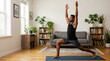 © Xenia - African American man practicing yoga in a warrior pose at home. Male doing a fitness workout on a mat in his living room. Home exercise and wellness concept