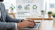 © Eduardo Accorinti - Businessman using laptop with interface to monitor corporate sustainability metrics, green initiatives and ESG reporting in a modern office