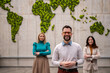 © Migma_Agency - Global business team standing in front of world map